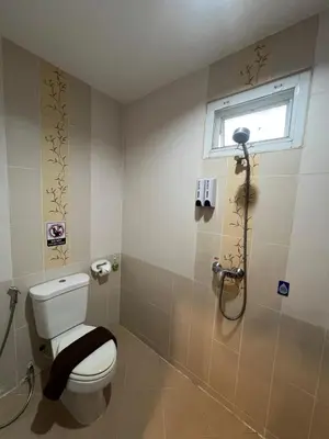 a bathroom with a toilet and a shower at SK Residence And Restaurant Patong in Patong Beach