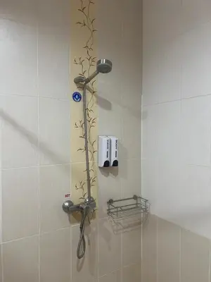a shower with a shower head in a bathroom at SK Residence And Restaurant Patong in Patong Beach