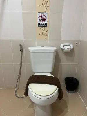 a bathroom with a toilet with a towel on it at SK Residence And Restaurant Patong in Patong Beach
