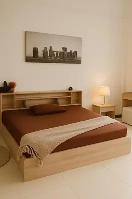 a bedroom with a large bed with a wooden frame at Green Terrace Residence Phuket in Kathu