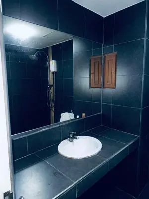 a bathroom with a sink and a mirror at Green Terrace Residence Phuket in Kathu