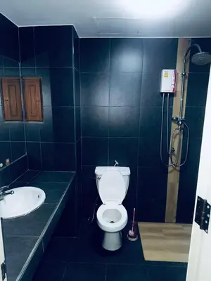 a bathroom with a toilet and a sink at Green Terrace Residence Phuket in Kathu