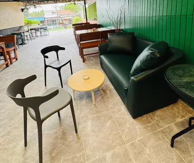 a living room with a couch and chairs and tables at Green Terrace Residence Phuket in Kathu