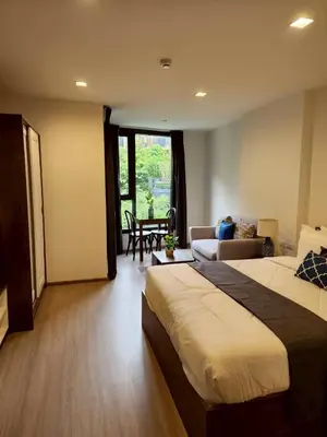 a hotel room with a bed and a living room at The Base Central Phuket-B42WL in Ban Rangeng