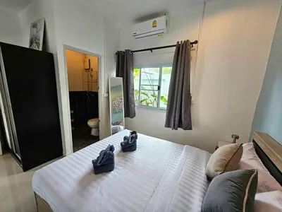 a bedroom with a bed with two shoes on it at Cozy 3 Bedrooms Pool Villa near Nai Harn Beach in Rawai Beach