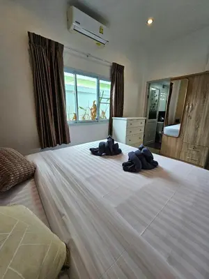a bedroom with a large bed with two stuffed animals on it at Cozy 3 Bedrooms Pool Villa near Nai Harn Beach in Rawai Beach