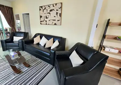 a living room with two black leather chairs and a table at Cozy 3 Bedrooms Pool Villa near Nai Harn Beach in Rawai Beach