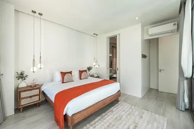 a bedroom with a large bed with a red blanket at V185 New Modern Villa with Private Pool in Bang Tao Beach