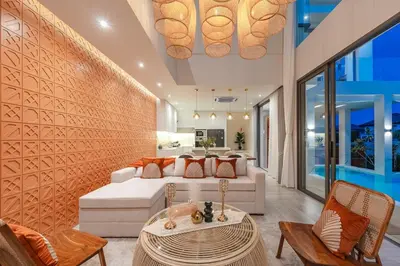 a living room with a bed and a table at V185 New Modern Villa with Private Pool in Bang Tao Beach