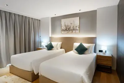 a hotel room with two beds and a window at Perfect Studio 3 pools Nai Harn in Rawai Beach