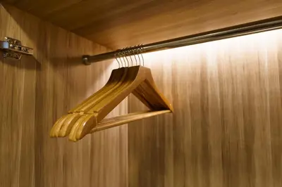 a wooden light fixture hanging from a wall at Perfect Studio 3 pools Nai Harn in Rawai Beach
