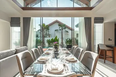 a dining room with a long glass table and chairs at V186 Quiet Glamour Oasis 4BR Poolside Sanctuary in Bang Tao Beach