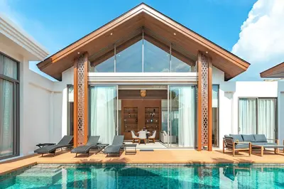 a villa with a swimming pool and a house at V186 Quiet Glamour Oasis 4BR Poolside Sanctuary in Bang Tao Beach