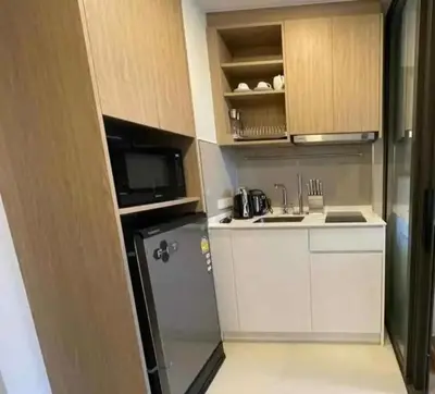 a small kitchen with a refrigerator and a sink at Аппартаменты Sky Park Laguna Phuket in Bang Tao Beach
