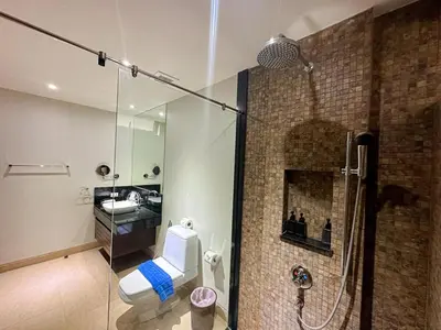 a bathroom with a shower and a toilet and a sink at NEW Malee Resort Studio 858 in Rawai Beach