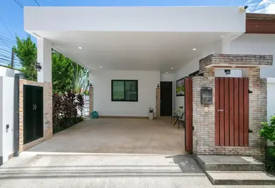 an open garage with a red door and a brick wall at V187 Walkable to Beach Very modern Jacuzzi pool in Rawai Beach