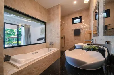 a bathroom with a tub and a sink at V187 Walkable to Beach Very modern Jacuzzi pool in Rawai Beach
