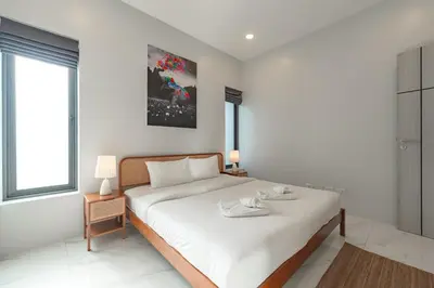a white bedroom with a large bed and a window at V189 Stylish 3BR Hideaway Pool & Beach Vibes in Rawai Beach