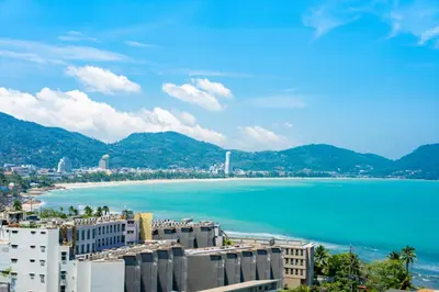 a view of a city and a body of water at Patong private spacious apart-ment 2 minutes walk to the beach bathtub sea view swimming pool in Patong Beach