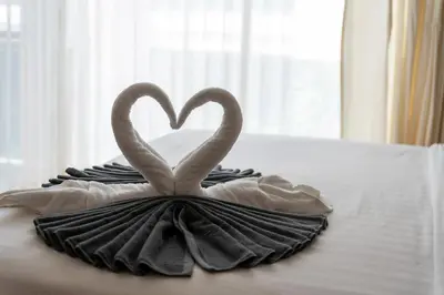 two swans forming a heart on a bed at Patong private spacious apart-ment 2 minutes walk to the beach bathtub sea view swimming pool in Patong Beach