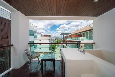 a balcony with a view of a building at Patong private spacious apart-ment 2 minutes walk to the beach bathtub sea view swimming pool in Patong Beach