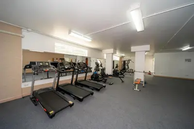 a gym with a row of treadmills and machines at Patong private spacious apart-ment 2 minutes walk to the beach bathtub sea view swimming pool in Patong Beach