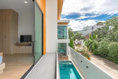 a view from the balcony of a house with a swimming pool at V190 Tropical Oasis 3BR Villa with Pool & Bathtub in Rawai Beach