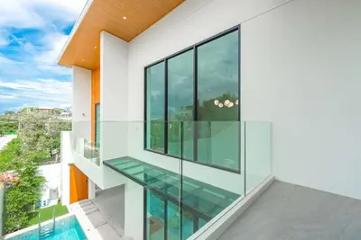 a house with glass windows and a swimming pool at V190 Tropical Oasis 3BR Villa with Pool & Bathtub in Rawai Beach