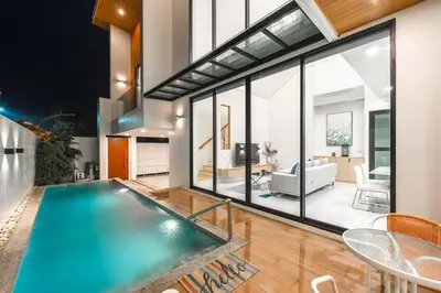an indoor swimming pool in a house with a living room at V190 Tropical Oasis 3BR Villa with Pool & Bathtub in Rawai Beach