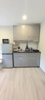 a kitchen with white cabinets and a refrigerator at B8 Ватсап669З5В2I976 in Nai Yang Beach