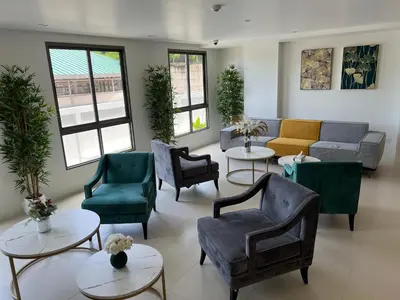 a waiting room with couches and chairs and tables at Fantasea Condominium Kamala in Kamala Beach