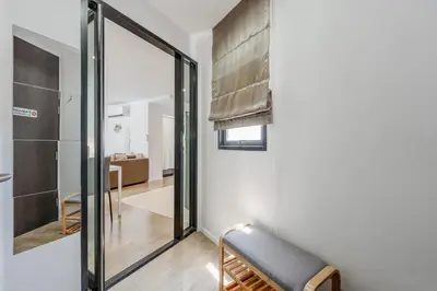 a room with a sliding glass door and a chair at C185 Centrio 2BR Condo Walk to Mall Near Town in Phuket Town
