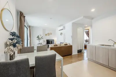 a kitchen and living room with a table and chairs at C185 Centrio 2BR Condo Walk to Mall Near Town in Phuket Town