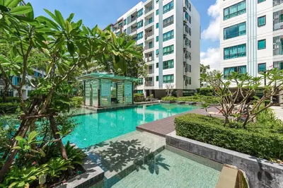 a swimming pool in the middle of a building at C185 Centrio 2BR Condo Walk to Mall Near Town in Phuket Town