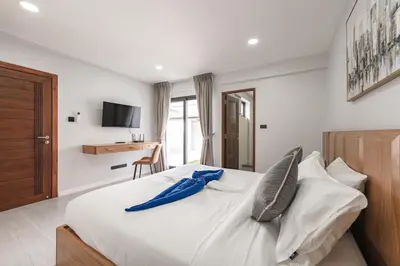 a bedroom with a large white bed with pillows at V192 Brand New Golf side 5BR Villa with Private Pool in Kathu