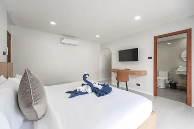 a bedroom with a bed with a swan decoration on it at V192 Brand New Golf side 5BR Villa with Private Pool in Kathu