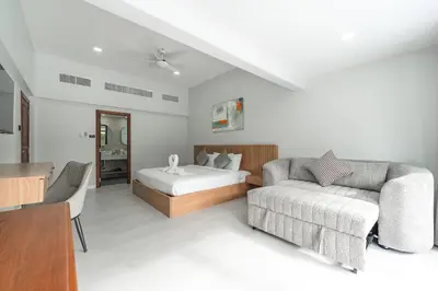 a hotel room with a bed and a couch at V192 Brand New Golf side 5BR Villa with Private Pool in Kathu