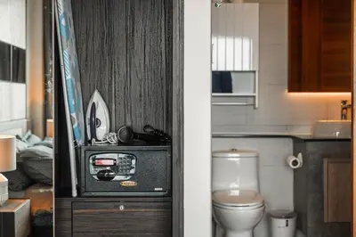 a bathroom with a toilet and a small television at C189 Beachside Luxury in Rawai Sea View and Gym in Rawai Beach