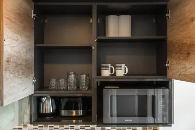 a kitchen with a cupboard with a microwave at C189 Beachside Luxury in Rawai Sea View and Gym in Rawai Beach