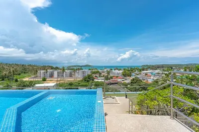 a swimming pool with a view of a city at C189 Beachside Luxury in Rawai Sea View and Gym in Rawai Beach