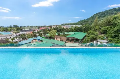 an aerial view of a swimming pool with a resort at C190 Sleek 1BR with Infinity Pool, Gym, Rooftop in Kamala Beach