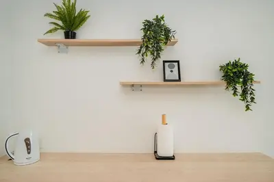 a room with wooden shelves and plants on the wall at C190 Sleek 1BR with Infinity Pool, Gym, Rooftop in Kamala Beach