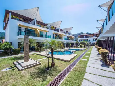 an exterior view of a resort with a swimming pool at 3-Bedroom Town House in Kamala in Kamala Beach