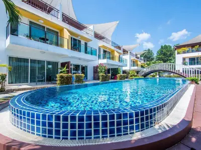 a swimming pool in front of a building at 3-Bedroom Town House in Kamala in Kamala Beach