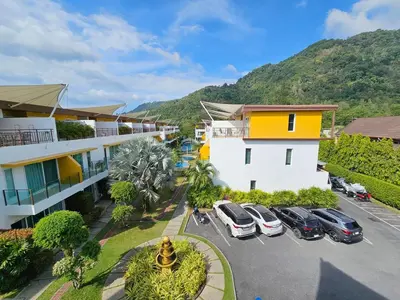 an aerial view of a hotel with cars parked in a parking lot at 3-Bedroom Town House in Kamala in Kamala Beach