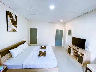 a white room with a bed with a butterfly on it at ANK Residence Patong in Patong Beach