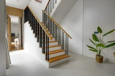 a staircase in a house with a potted plant at Modern 3 Bdr Villa Tree O'Clock Bangtao With a Pool in Ban Pak Lak