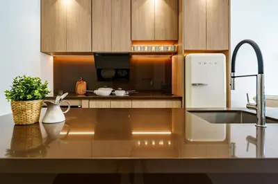 a kitchen with wooden cabinets and a sink and a refrigerator at Modern 3 Bdr Villa Tree O'Clock Bangtao With a Pool in Ban Pak Lak