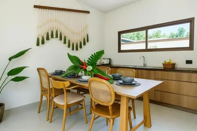 a dining room with a table and chairs at Modern 3 Bdr Villa Tree O'Clock Bangtao With a Pool in Ban Pak Lak