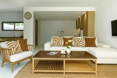 a living room with a couch and a coffee table at Modern 3 Bdr Villa Tree O'Clock Bangtao With a Pool in Ban Pak Lak
